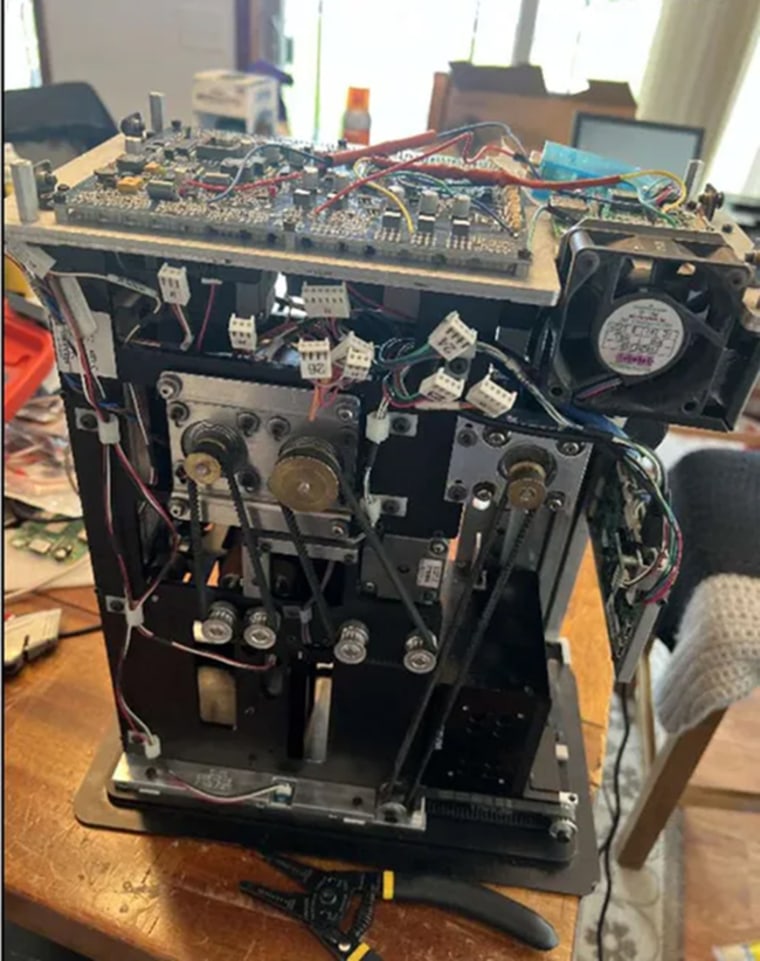 Image of a DeckMate 2 shuffler taken apart on a table, from defendant Shane Hennen